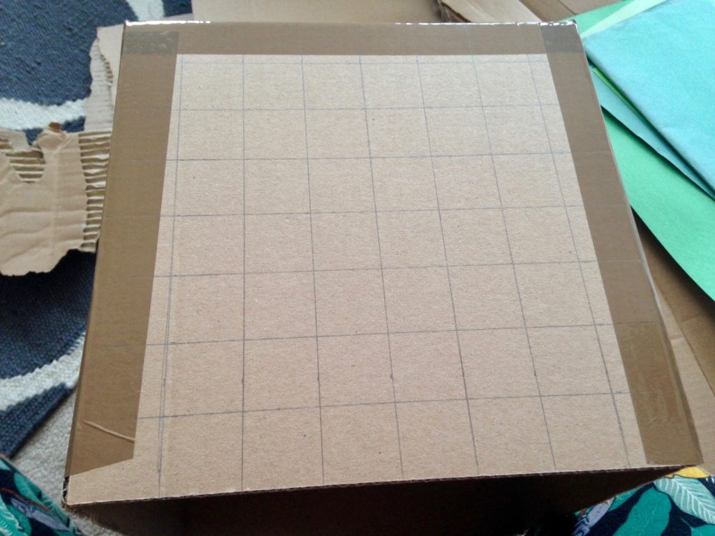 Mark the box into a 3cm square grid